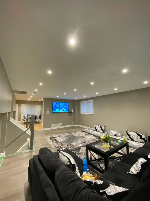 Recessed ceiling lights brighten a finished basement living area