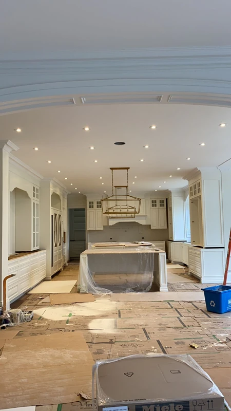 Ceiling pot lights and suspended fixtures in a home undergoing renovation